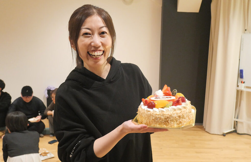 10周年のケーキを抱えたスタッフ